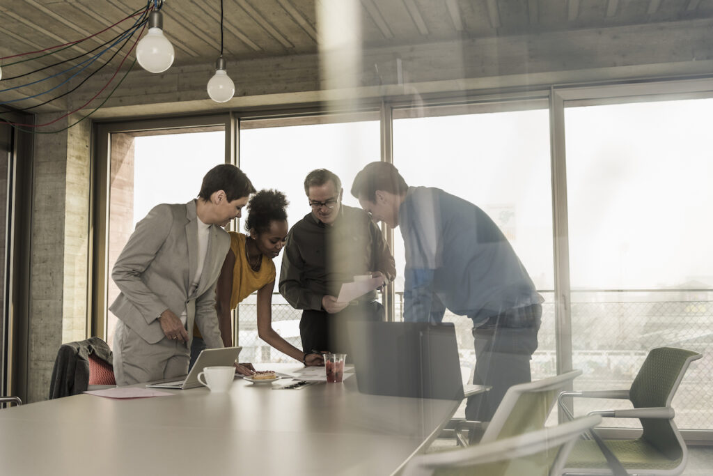 employees in a meeting organizing a business continuity and disaster recovery plan