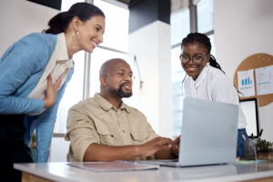 employees looking at computer discussing it challenges