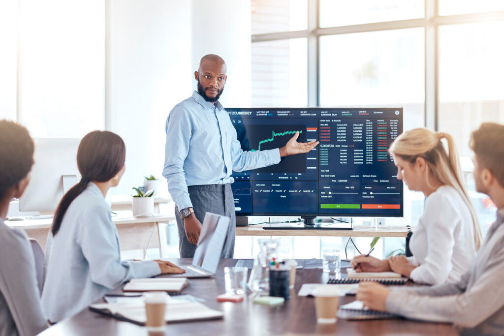 A team in an office pointing at screen