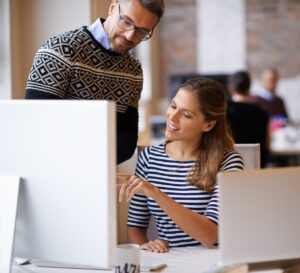 coworkers working on computer at office
